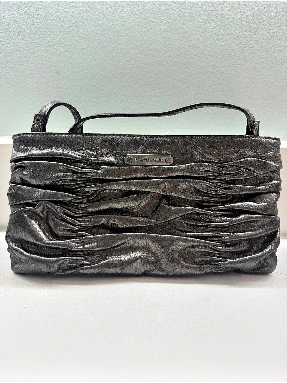 Michael Kors Ruched Leather evening Bag with strap in Gun Metal color.